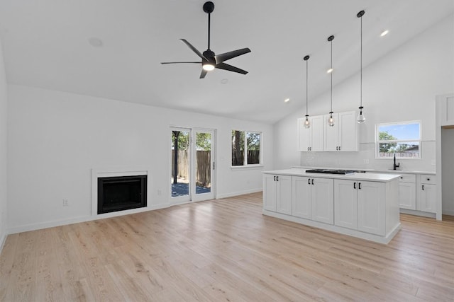 3405 Dunliegh Dr, Austin, TX 78745 - kitchen with a ceiling fan, gas cooktop, light wood finished floors, high vaulted ceiling, and plenty of natural light