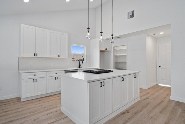 3405 Dunliegh Dr, Austin, TX 78745 - kitchen featuring high vaulted ceiling, white cabinetry, a center island, light wood-style floors, and recessed lighting