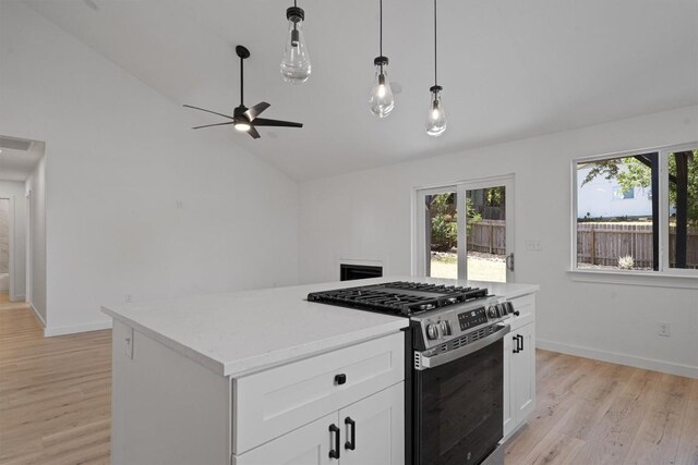 3405 Dunliegh Dr, Austin, TX 78745 - kitchen with stainless steel gas range oven, plenty of natural light, a ceiling fan, light wood-style flooring, and high vaulted ceiling