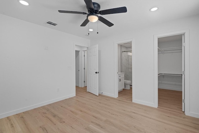 3405 Dunliegh Dr, Austin, TX 78745 - unfurnished bedroom featuring a spacious closet, light wood-style floors, a closet, recessed lighting, and ensuite bath