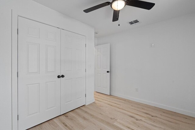 3405 Dunliegh Dr, Austin, TX 78745 - unfurnished bedroom featuring light wood-type flooring, a closet, and a ceiling fan