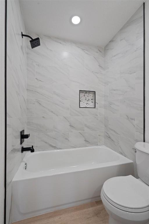 3405 Dunliegh Dr, Austin, TX 78745 - full bathroom featuring shower / washtub combination and wood finished floors