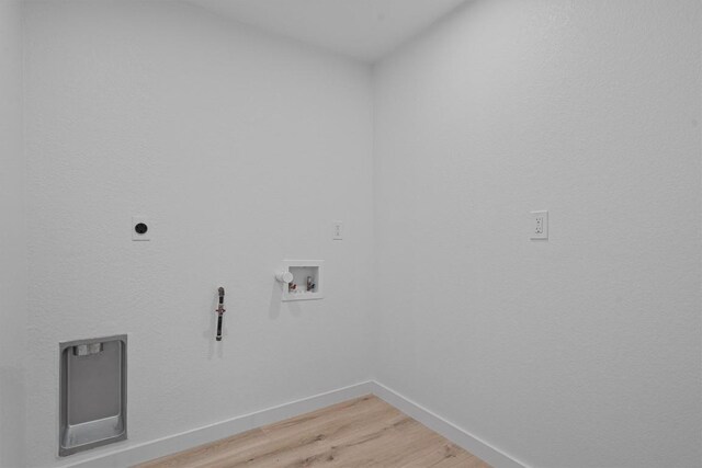 3405 Dunliegh Dr, Austin, TX 78745 - laundry area featuring light wood-style flooring, hookup for a washing machine, and hookup for an electric dryer