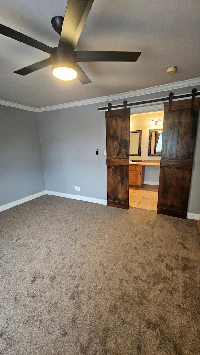 2500 Steck Ave Unit 13, Austin, TX 78757 - unfurnished room featuring a barn door, crown molding, a ceiling fan, light colored carpet, and a smoke detector