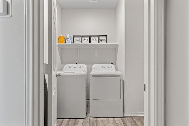 1925 T H Johnson Dr, Taylor, TX 76574 - laundry area featuring separate washer and dryer and light wood-style flooring