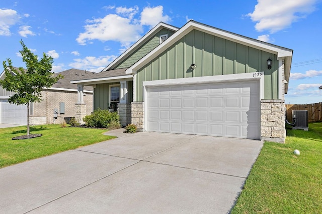1925 T H Johnson Dr, Taylor, TX 76574 - view of front of property with board and batten siding, stone siding, a front lawn, and an attached garage