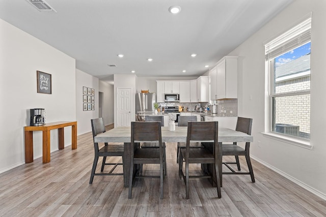 1925 T H Johnson Dr, Taylor, TX 76574 - dining space with light wood finished floors and recessed lighting
