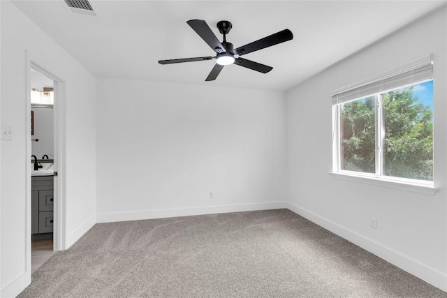 111 Woodley Rd, Leander, TX 78641 - unfurnished bedroom featuring carpet flooring, connected bathroom, and ceiling fan