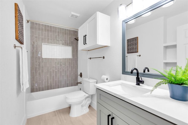 111 Woodley Rd, Leander, TX 78641 - bathroom featuring vanity,  shower combination, and wood finished floors
