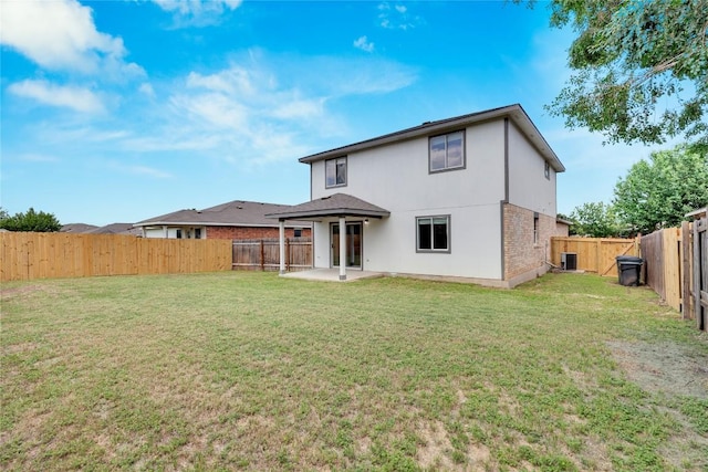 111 Woodley Rd, Leander, TX 78641 - back of house featuring a patio area, a fenced backyard, and brick siding