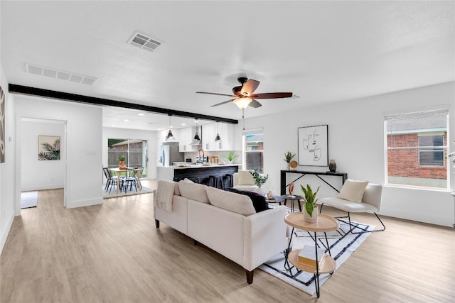 111 Woodley Rd, Leander, TX 78641 - living area featuring light wood finished floors, healthy amount of natural light, a ceiling fan, and recessed lighting