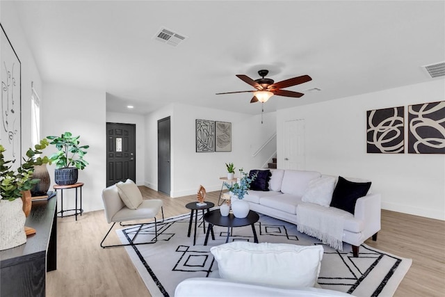 111 Woodley Rd, Leander, TX 78641 - living room with stairs, a ceiling fan, light wood-style floors, and recessed lighting