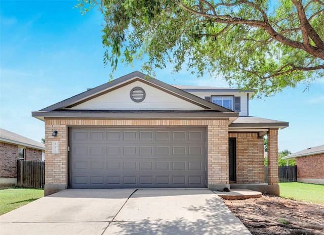 111 Woodley Rd, Leander, TX 78641 - view of front facade with concrete driveway, brick siding, and a garage