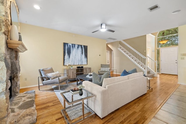 8204 Ito Cv, Austin, TX 78729 - living area featuring stairway, wood finished floors, a ceiling fan, recessed lighting, and a fireplace