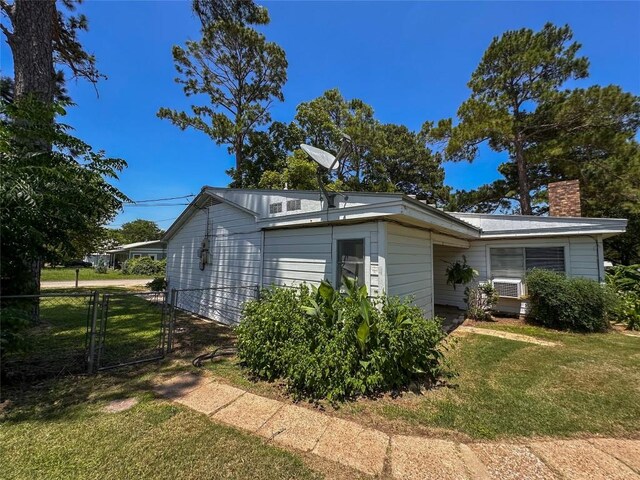 407 4th Ave, Smithville, TX 78957 - view of home's exterior featuring a chimney and a gate