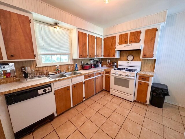 407 4th Ave, Smithville, TX 78957 - kitchen featuring white appliances, under cabinet range hood, light countertops, and light tile patterned floors