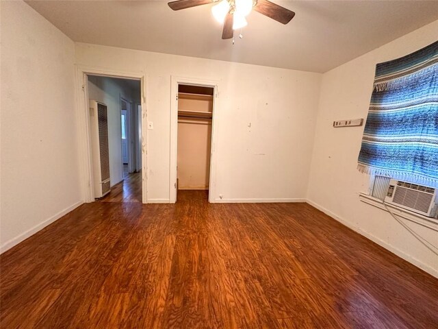 407 4th Ave, Smithville, TX 78957 - unfurnished bedroom featuring wood finished floors, a heating unit, a ceiling fan, cooling unit, and a closet