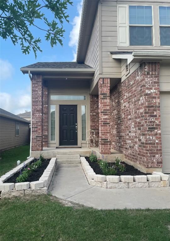 12201 Walter Vaughn Dr, Manor, TX 78653 - doorway to property with brick siding