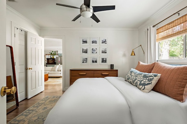 7303 Lunar Dr, Austin, TX 78745 - bedroom with ornamental molding, wood finished floors, and ceiling fan