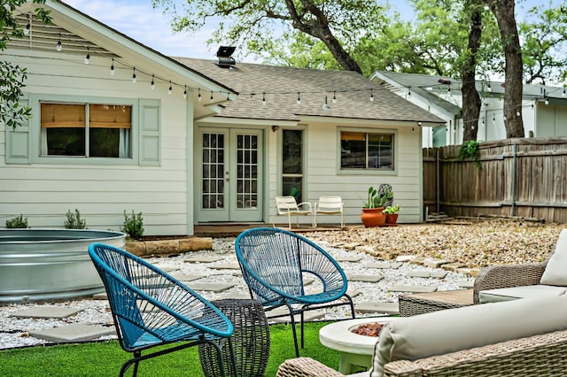 7303 Lunar Dr, Austin, TX 78745 - rear view of property featuring french doors, a patio area, and a shingled roof