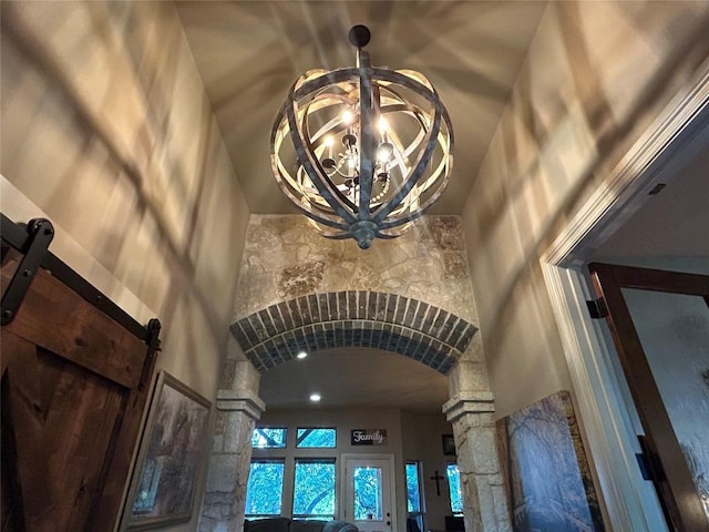 304 Bluestem Cv, Georgetown, TX 78633 - detailed view of decorative columns, arched walkways, a barn door, and a chandelier