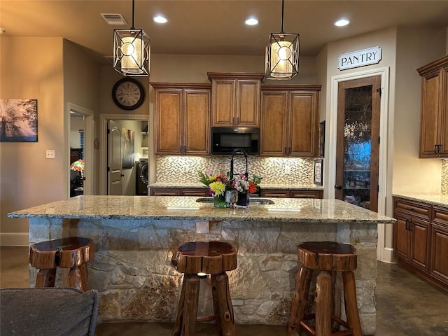 304 Bluestem Cv, Georgetown, TX 78633 - kitchen featuring black microwave, tasteful backsplash, light stone countertops, and recessed lighting