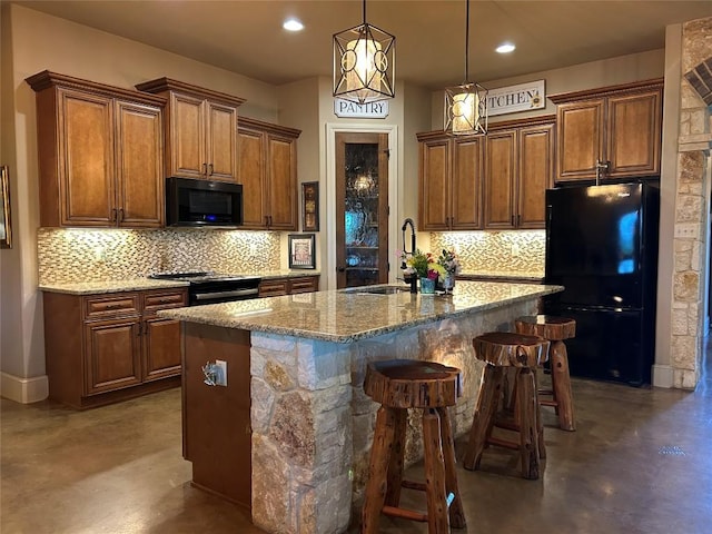304 Bluestem Cv, Georgetown, TX 78633 - kitchen with black appliances, finished concrete floors, tasteful backsplash, light stone countertops, and recessed lighting