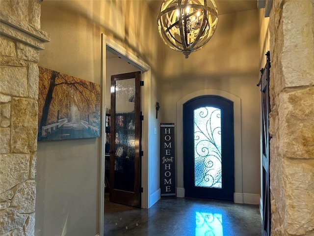 304 Bluestem Cv, Georgetown, TX 78633 - entryway with concrete flooring, a barn door, arched walkways, and a chandelier