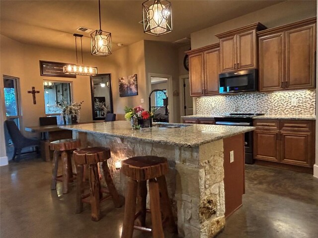 304 Bluestem Cv, Georgetown, TX 78633 - kitchen featuring finished concrete floors, electric range oven, decorative backsplash, and a breakfast bar area