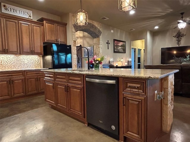 304 Bluestem Cv, Georgetown, TX 78633 - kitchen with dishwasher, black refrigerator, open floor plan, a kitchen island with sink, and pendant lighting