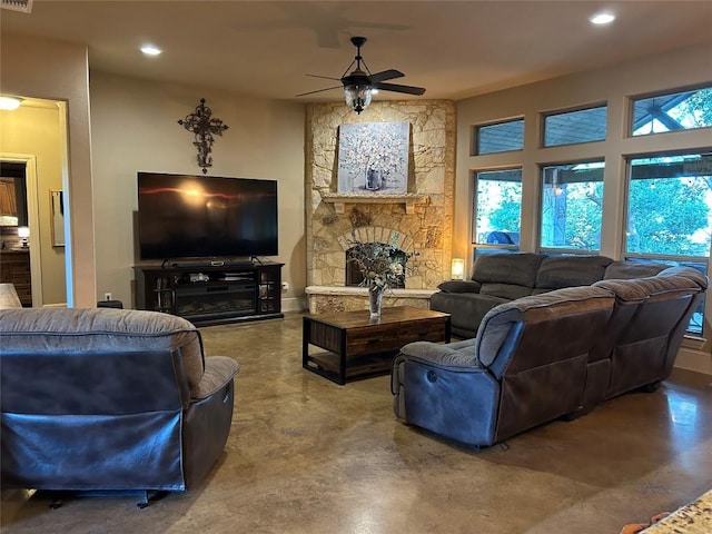 304 Bluestem Cv, Georgetown, TX 78633 - living area with a ceiling fan, concrete flooring, recessed lighting, and a fireplace