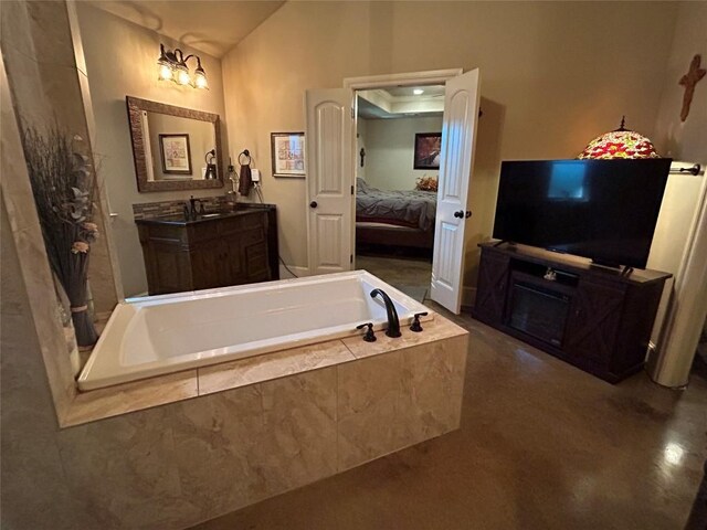 304 Bluestem Cv, Georgetown, TX 78633 - ensuite bathroom featuring a bath, vanity, and lofted ceiling