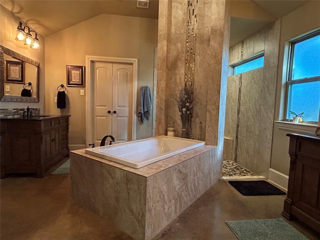 304 Bluestem Cv, Georgetown, TX 78633 - bathroom with a bath, vaulted ceiling, vanity, and a walk in shower