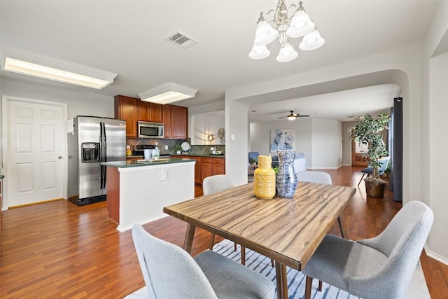 517 Castebar Dr, Round Rock, TX 78664 - dining area featuring a chandelier, dark wood-style flooring, and a ceiling fan