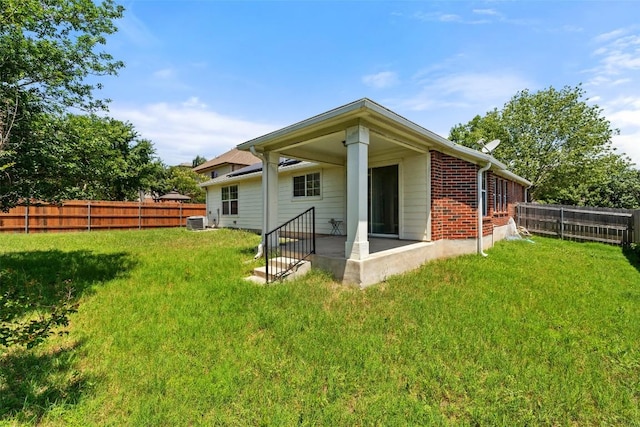 517 Castebar Dr, Round Rock, TX 78664 - back of property featuring a fenced backyard, brick siding, and a patio area