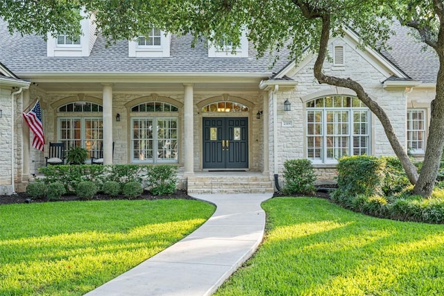 2319 Woodway Dr, Round Rock, TX 78681 - property entrance with stone siding, a shingled roof, and a yard