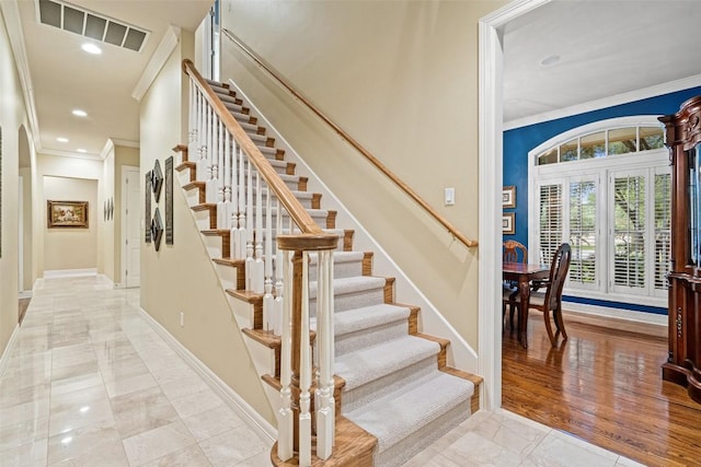 2319 Woodway Dr, Round Rock, TX 78681 - staircase featuring ornamental molding, recessed lighting, arched walkways, and marble finish flooring