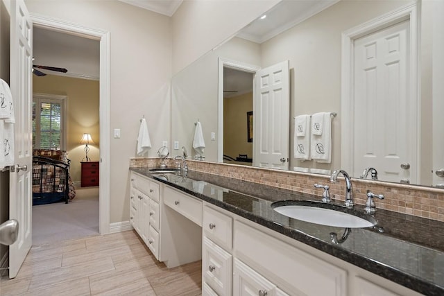 2319 Woodway Dr, Round Rock, TX 78681 - ensuite bathroom featuring double vanity, crown molding, decorative backsplash, ceiling fan, and wood finished floors