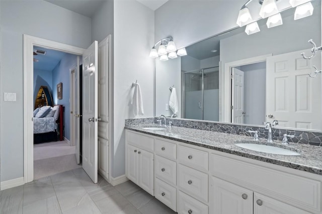 2319 Woodway Dr, Round Rock, TX 78681 - bathroom with double vanity, a stall shower, ensuite bath, and marble finish flooring