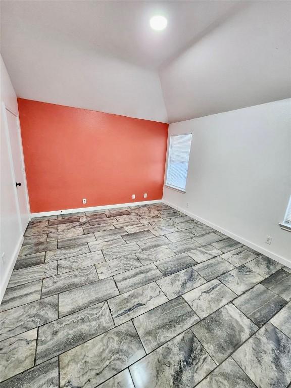 16828 Jaron Dr, Manor, TX 78653 - additional living space with vaulted ceiling and baseboards