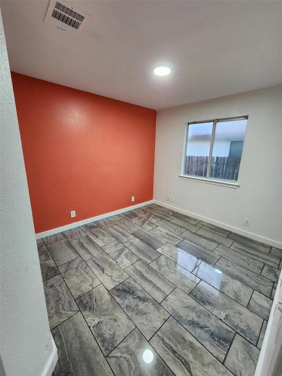 16828 Jaron Dr, Manor, TX 78653 - unfurnished room featuring recessed lighting and marble look tiles
