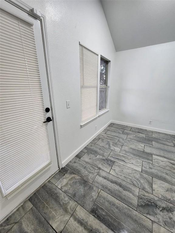 16828 Jaron Dr, Manor, TX 78653 - interior space featuring vaulted ceiling and baseboards