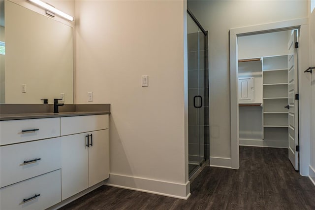 2009 Iroquois Ln Unit B, Austin, TX 78741 - bathroom featuring wood finished floors, a stall shower, vanity, and a spacious closet