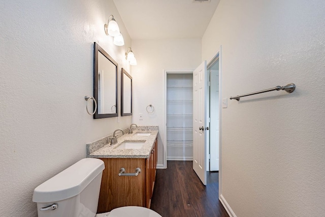 18111 Gallant St, Manor, TX 78653 - bathroom with wood finished floors, vanity, and a textured wall