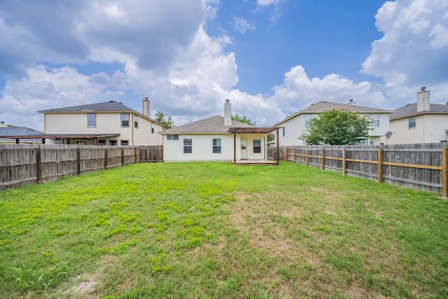 18111 Gallant St, Manor, TX 78653 - rear view of house featuring a fenced backyard, a patio, and a chimney
