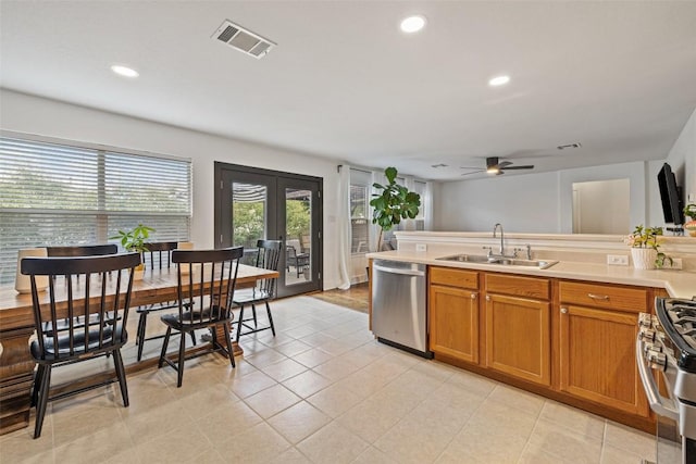 216 Prairie Verbena Dr, Kyle, TX 78640 - kitchen featuring appliances with stainless steel finishes, brown cabinets, ceiling fan, light countertops, and recessed lighting