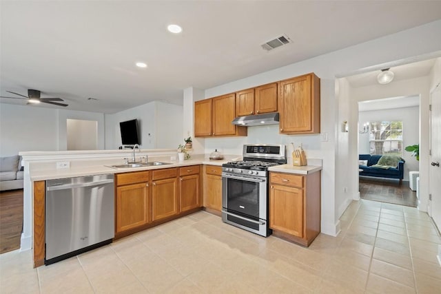 216 Prairie Verbena Dr, Kyle, TX 78640 - kitchen featuring stainless steel appliances, under cabinet range hood, open floor plan, light countertops, and a peninsula