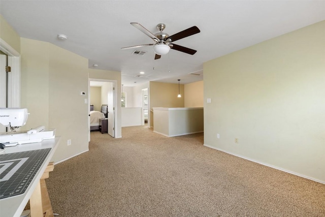 216 Prairie Verbena Dr, Kyle, TX 78640 - unfurnished living room featuring light carpet and a ceiling fan