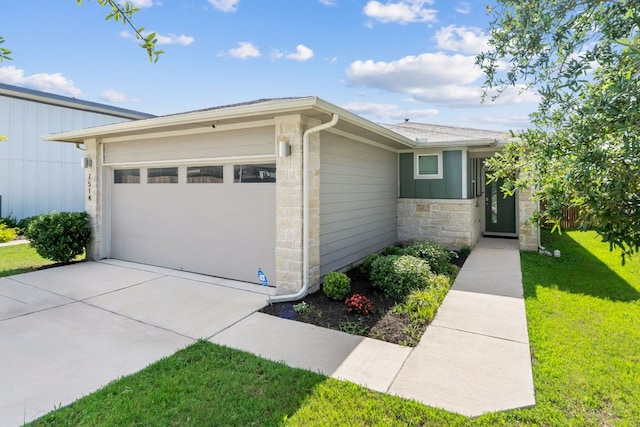 7514 Daves Landing Dr, Austin, TX 78724 - view of front facade with stone siding, a front lawn, an attached garage, and driveway