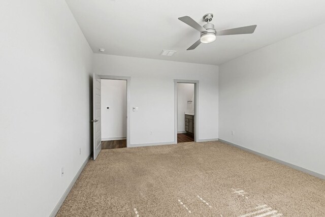 7514 Daves Landing Dr, Austin, TX 78724 - unfurnished bedroom featuring carpet flooring, connected bathroom, and ceiling fan